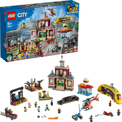 A LEGO City building set is displayed with its box and all the individual components laid out.