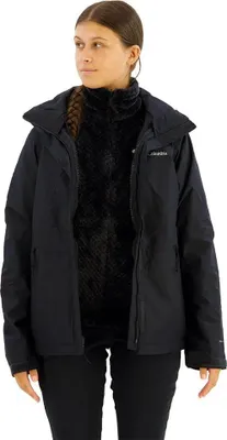 A young woman is wearing a black Columbia jacket over a black fleece vest.