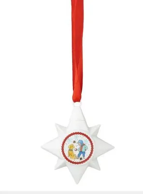 A white star-shaped ornament with a red ribbon hanging from the top. The ornament has a circular image in the center depicting a boy and a dog.