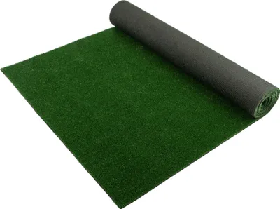 A roll of green artificial grass is partially unrolled on a white surface.