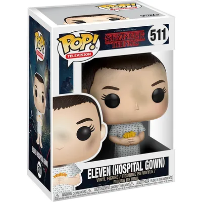 A Funko Pop! vinyl figure of Eleven from Stranger Things in a hospital gown, displayed in its original packaging.
