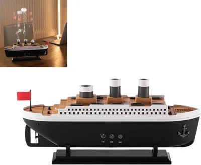 A product shot of a ship-shaped aromatherapy diffuser, with a smaller inset image showing it in a home office setting.