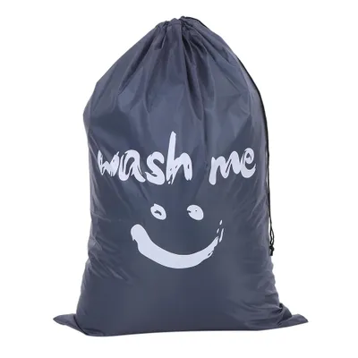 A gray laundry bag with a smiley face and the words 'wash me' printed on it.