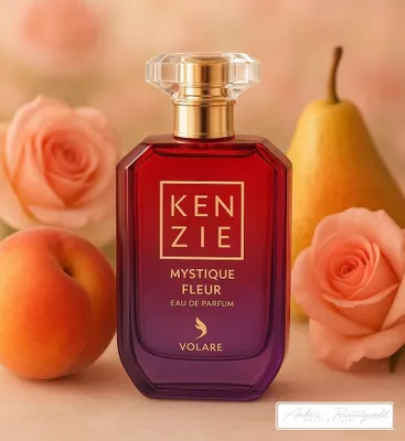 A perfume bottle is displayed with fruit and flowers in the background.