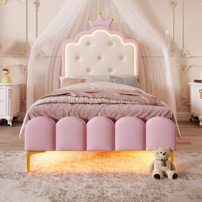 A child's princess-themed bed with a crown headboard and LED lighting.
