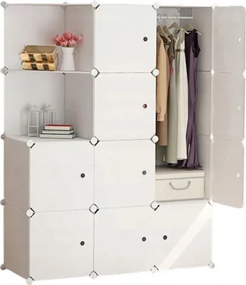 A modular white wardrobe with clothes hanging inside and some items on shelves.