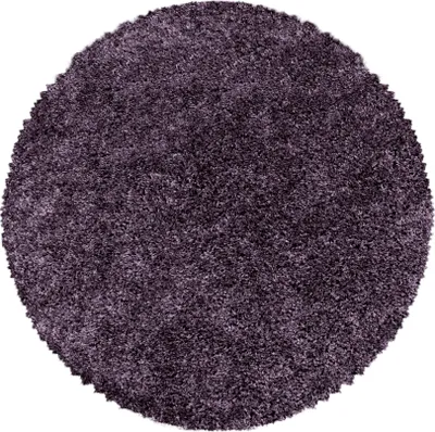 A round, fluffy rug in a dark violet color.