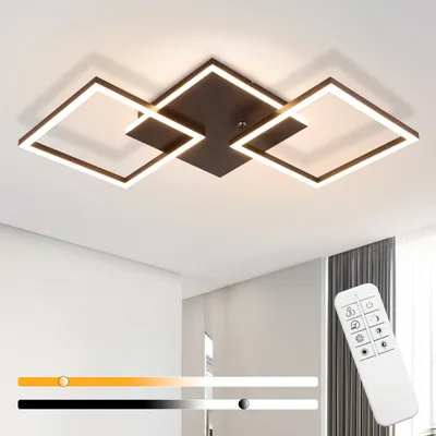 A modern black ceiling lamp with square frames and integrated LED lighting, shown mounted on a white ceiling. A remote control is visible in the foreground, along with a color temperature slider.