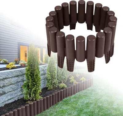 A garden border made of brown plastic palisades is installed along a raised garden bed and lawn.