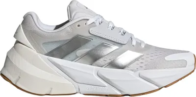 A white Adidas running shoe with silver stripes is shown against a white background.