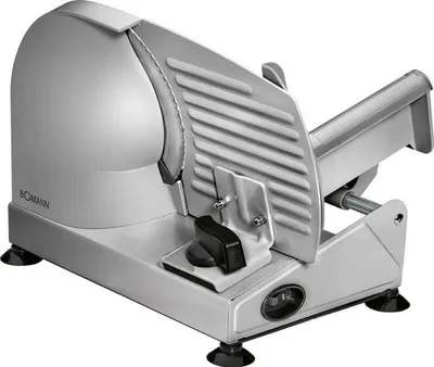 A silver electric slicer with a ribbed cutting guard and a black adjustment knob sits on a white background.