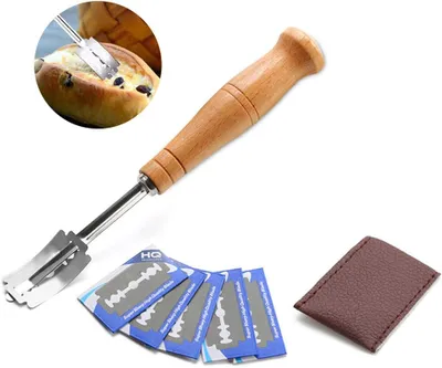 A bread lame with a wooden handle, several replacement blades, and a small leather pouch, presented on a white background.