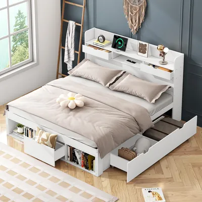 A bedroom setting with a white bed frame featuring storage drawers and a headboard with shelves.