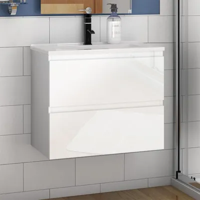 A white bathroom vanity with a black faucet and a soap dispenser.