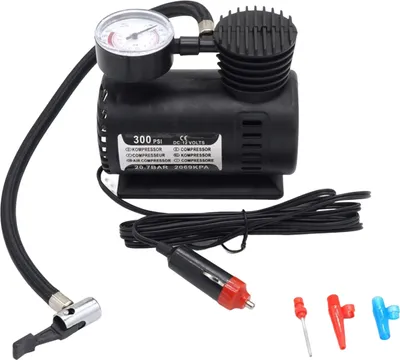 A black electric air compressor with a pressure gauge, hose, and car adapter, along with several nozzle attachments, is displayed against a white background.