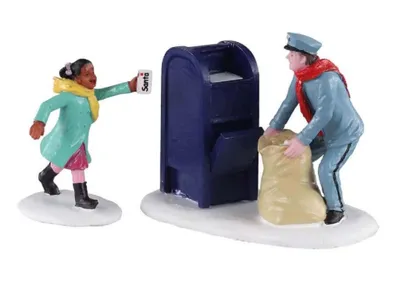 Mädchens das einen Brief mit der Aufschrift "Santa" in einen blauen Briefkasten wirft.