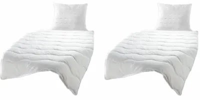 Two white duvets and pillows are shown against a white background.