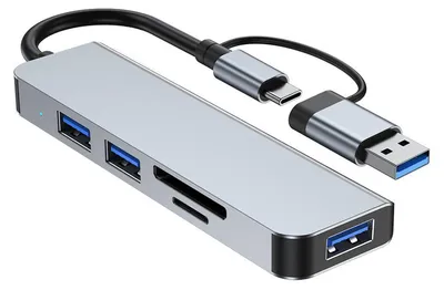 A silver USB hub with multiple ports and attached cables is shown against a white background.