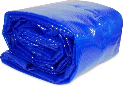 A rolled-up blue solar cover for a round pool.