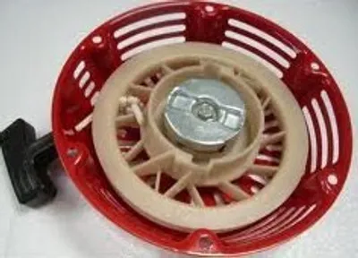 A close-up view of a red starter assembly with a black pull handle.