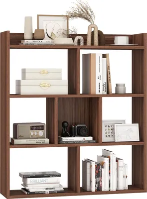 A wooden bookshelf filled with books and decorative items.