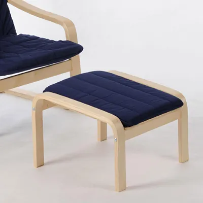 A close-up shot of a wooden ottoman with a blue cushion.