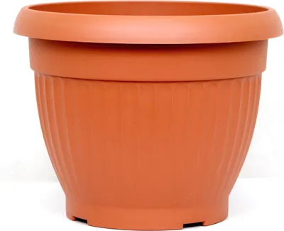 A terracotta-colored plastic plant pot with a ribbed texture.
