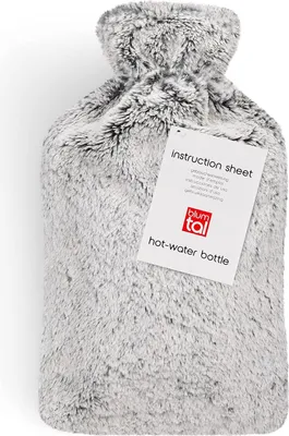 A fluffy hot water bottle with an instruction sheet attached.