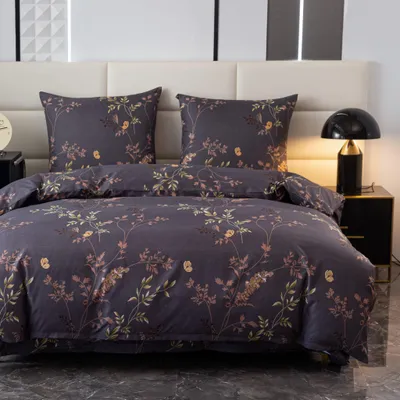 A close-up view of a floral patterned duvet and pillow set on a bed.