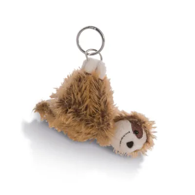 A plush sloth keychain lying on its side against a white background.