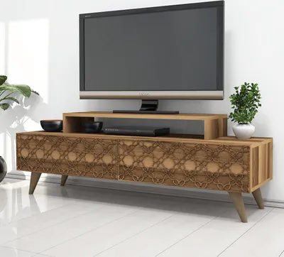 A TV stand with a television and decorative items in a room.