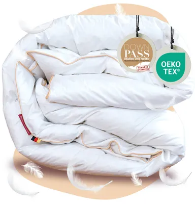 A folded white duvet with decorative stitching and tags attached.