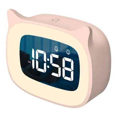 A pink digital alarm clock with a cat-ear design, displaying the time 10:58 PM, is shown against a white background. A person is visible sleeping in the background reflection on the clock's screen.