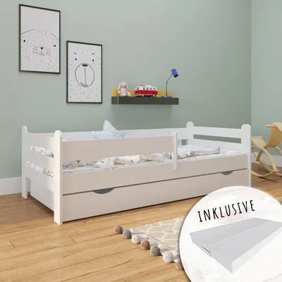 A child's bedroom with a white bed, toys, and artwork on the wall.