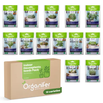 A collection of indoor houseplant seed packets and a cardboard box containing them.