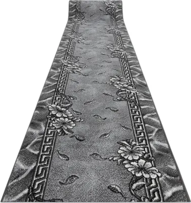 A long, narrow rug with a floral and fish pattern is shown from a diagonal perspective.