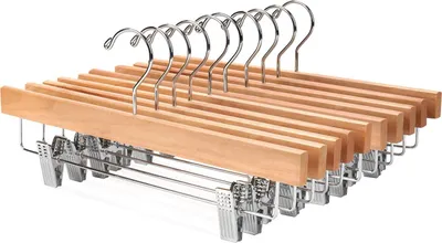 A set of wooden hangers with metal clips on a white background.