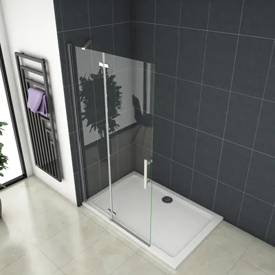 A modern shower enclosure with a glass door and white tray, set against dark gray tiled walls and a light tiled floor.