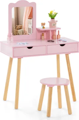 A pink children's vanity desk and stool set with a mirror and accessories.