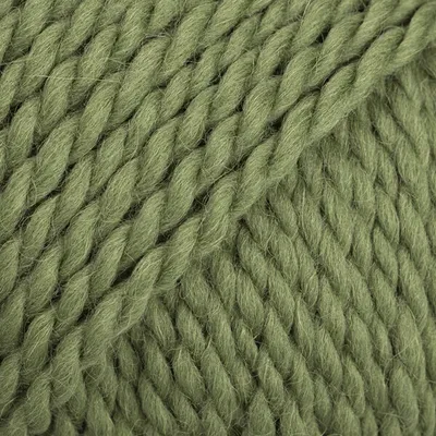 A close-up, textured view of green yarn.