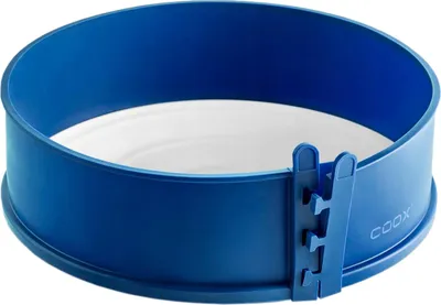 A blue springform cake pan with a white insert, shown from a slightly elevated diagonal angle.