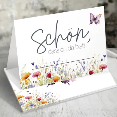 A folded greeting card with a floral and butterfly design.