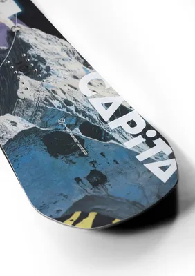 Close-up of a snowboard with a graphic design.