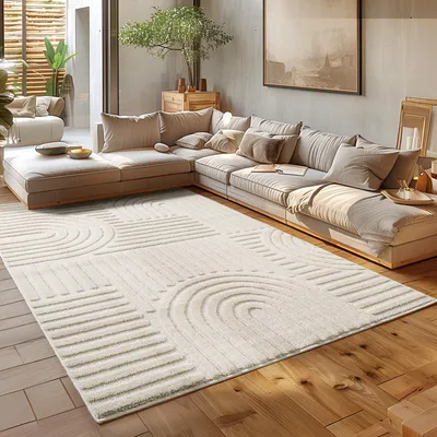 A modern living room with a large sectional sofa and a rug.