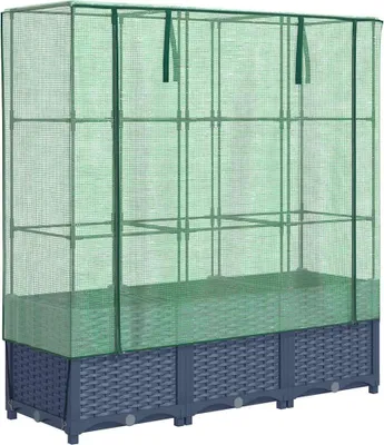 A greenhouse attached to a raised garden bed.