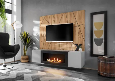 A modern living room with a TV unit, fireplace, and armchair.
