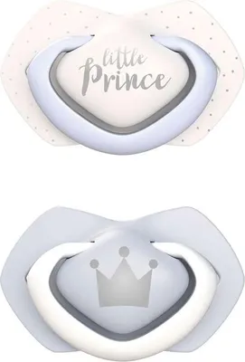 Two baby pacifiers are shown against a white background. The top pacifier has a white shield with small gray dots and the words "little Prince" printed in gray. The bottom pacifier has a light blue shield with a gray crown graphic.