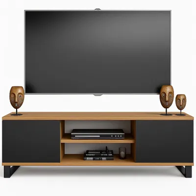 A TV stand with a television on top, and decorative masks on either side.