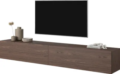 A modern TV stand with a television mounted above it, and decorative items on the stand.