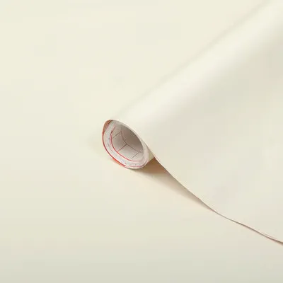 A roll of white adhesive film is shown diagonally on a light background.
